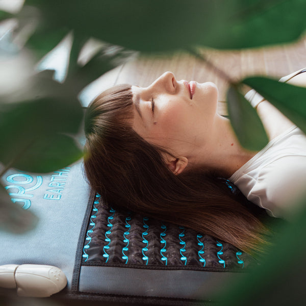 Person relaxing on Grooni mat outdoors