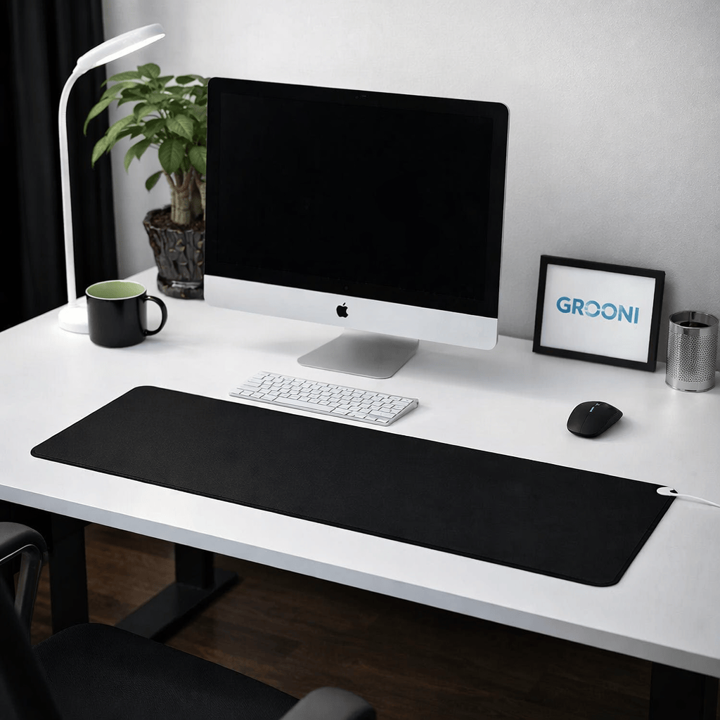 Modern office desk setup with computer monitor, keyboard, mouse, and desk accessories.