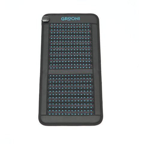 Black chair pemf mat with grid pattern and 'Grooni' branding on a white background