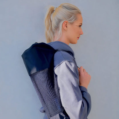 Woman holding a grounding yoga mat 