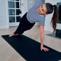 Woman practicing yoga over a grounding yoga mat