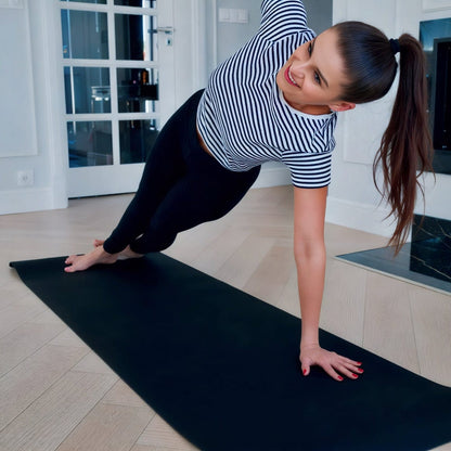 Woman practicing yoga over a grounding yoga mat
